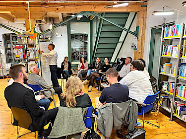 Teilnehmerinnen und Teilnehmer sitzen bei einem Workshop zusammen